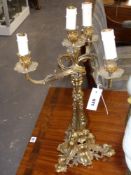 A gilt bronze four light candelabrum in the rococo taste mounted as a lamp