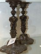 A pair of Antique bronze French candlesticks decorated in the Renaissance revival manner