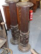 A pair of early carved oak columns with cherub and motif decoration