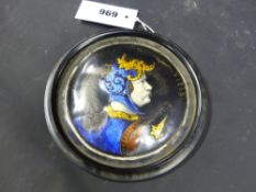An Antique enamel circular plaque decorated with a bust portrait of a warrior, possibly Limoges