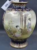 A finely decorated Satsuma baluster form vase decorated with panels of figures on a gilt decorated