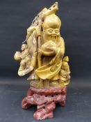 A Chinese carved soapstone figure of a standing sage on rock form base