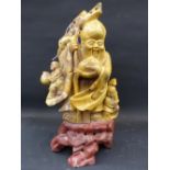 A Chinese carved soapstone figure of a standing sage on rock form base