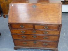 A late 18th.c.mahogany bureau with well fitted shaped interior over two short and three long