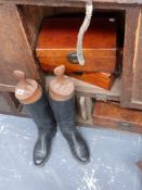 A pair of leather riding boots and three leather bound boxes