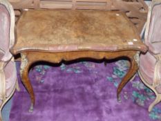 A 19th century walnut serpentine fold over card table on shaped legs with gilt bronze mounts. In the