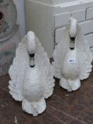A pair of painted swan form garden ornaments