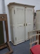 An antique north european white painted large armoire