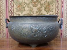 A large Oriental bronze twin handle jardiniere with dragon decoration. Character mark to base