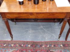 An early 19th.c.mahogany two drawer side table by Wilson of London with side slides