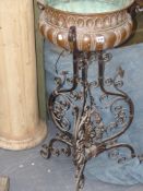 An antique wrought iron and copper Jardiniere