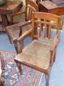 A set of six colonial hardwood open armchairs with cane seats