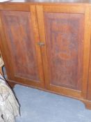 A large antique carved oak two door cabinet the doors carved with designs from........... together