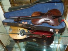 An early 19th Century violin two piece maple back, indistinct hand written label within. In later