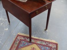 A large Georgian mahogany drop leaf Pembroke table on square tapered legs