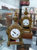 A near pair of Victorian gilt brass and coloured glass mounted striking mantle clocks