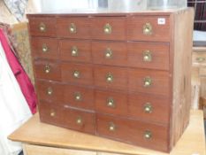 A bank of twenty pine spice drawers