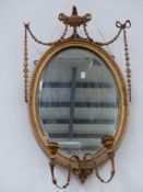 A pair of gilt framed Adam's style girandole mirrors