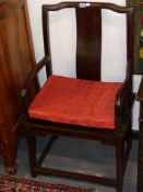 A pair of Chinese carved hardwood armchairs of classical form