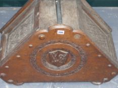 A Victorian carved oak large coal box decorated with armorial crest of Corpus Christi College and