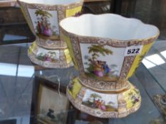 A pair of German cache pots decorated in the 18th Century Meissen style with figures and flowers