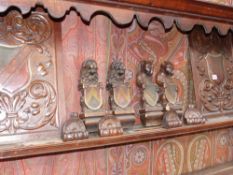 A pair of carved oak panels with shield decoration and other animal form elements