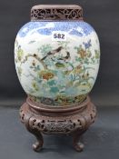 A Chinese ginger jar with famille verte bird and insect decoration. Encircled double ring mark