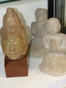 An Eastern carved marble Deity head and two kneeling figures