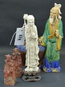 A Chinese pottery figure of a sage with a large vase, two figural seals and another figure of a