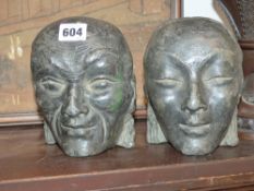 An unusual pair of Oriental face masks. Cast in lead. Possibly Japanese