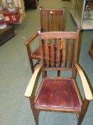 A pair of Arts and Crafts oak armchairs