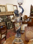 An Antique carved and decorated blackamoor standing torchere figure adapted as a lamp