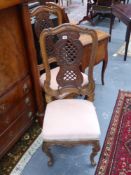 A pair of continental hall chairs with carved pierced backs