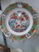 An unusual Derby plate decorated in the famille verte style with birds and foliage. Gilt rim and