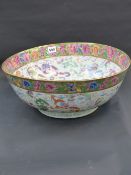 A large Chinese export famille rose punch bowl with floral and gilt banded rim, the interior and