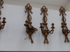 Four carved giltwood twin light sconces and a mirrored pair