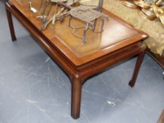 A mahogany and leather inset large coffee table