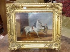 19th.C. English School A stallion and groom oil on board in carved giltwood frame