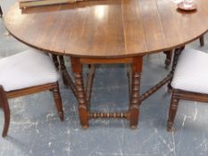 A large 19th.c.oak double gateleg drop leaf dining table on bobbin turned legs