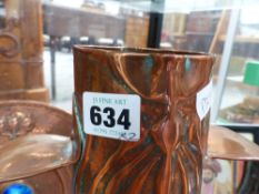 An arts and crafts Newlyn school copper tall vase with embossed decoration together with a similar