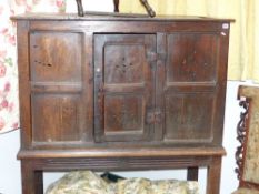 An early oak cabinet on associated stand