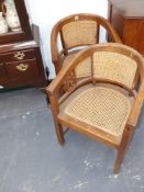 A pair of colonial hardwood bow back cane seat armchairs