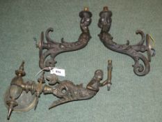 A pair of bronze figural wall lights, and another similar (electrified former gas lights)