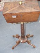 A Regency flame mahogany teapoy on turned column and scroll legs