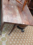 A mid Georgian solid yew wood drop leaf dining table