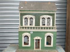 An antique painted dolls house