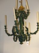 A pair of twelve light rococo style chandeliers foliate form scrolling branches