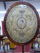 A Wm.IV.mahogany pole screen with silk embroidered oval panel