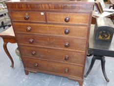 An early Victorian oak chest of two short and four long graduated drawers