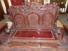 An impressive Japanese carved hall settle with dragon crest rail and arms ,box seat
